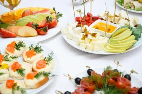 Buffet table with fruit and meat snacks and canapés Stock Photos
