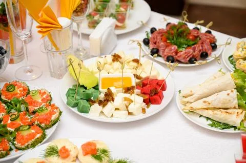 Buffet table with fruit and meat snacks and canapés Stock Photos