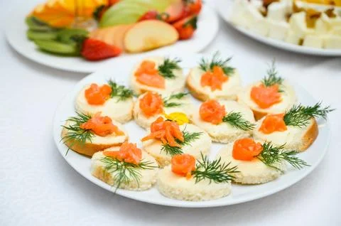 Buffet table with fruit and meat snacks and canapés Stock Photos