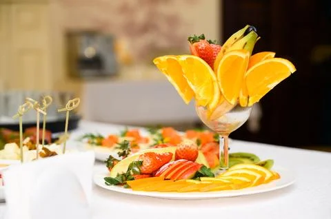 Buffet table with fruit and meat snacks and canapés Stock Photos