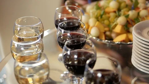 Buffet table with glasses of white and red wine and snacks in the form of Video stock 119953156