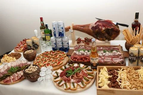 Buffet table with jamon, Corona Extra, Blanc 1664, Jameson, Becherovka and as Stock Photos
