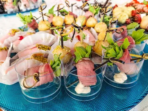 Buffet table. Many different snacks on skewers are on the plate. Stock Photos