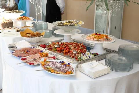 Buffet table offering various delicious dishes during a catered event 스톡 사진