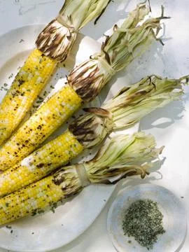 A buffet table set up in a garden for al al fresco meal. sweetcorn, corn  Fotos de archivo