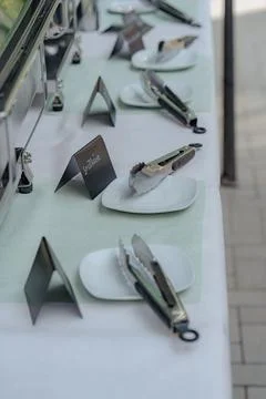 Buffet Table Setup with Plates and Serving Tongs Stock Photos