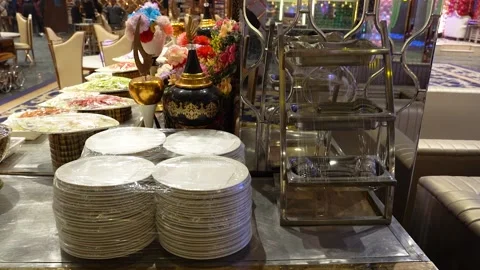 Buffet table setup with stacked plates and catering equipment Stock Footage 341763597