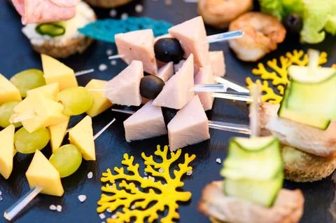 Buffet table. Snacks for the banquet. Meat and fruit plates Stock Photos