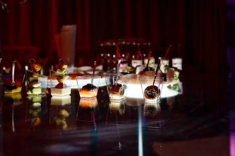 Buffet table with toasts and snacks and desserts in red tones Stock Photos