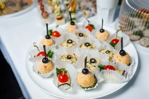 Buffet table with toasts and snacks and desserts Stock Photos