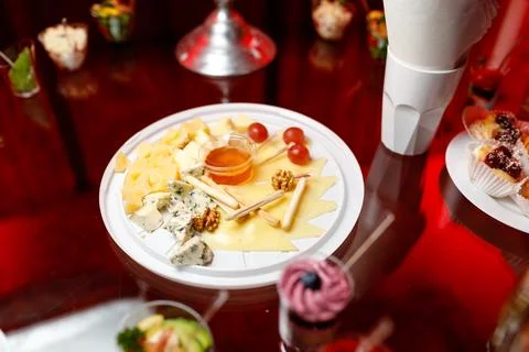 Buffet table with toasts and snacks and desserts and cheese plate Stock Photos