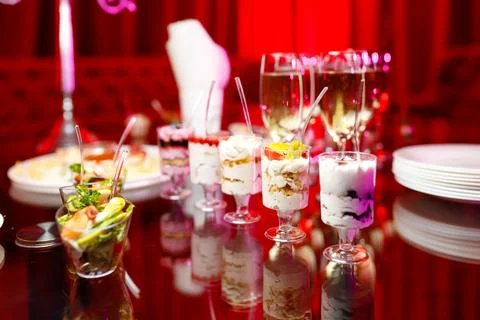 Buffet table with toasts and snacks and desserts in red tones Stock Photos