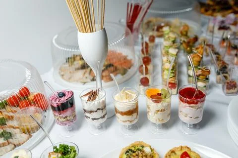 Buffet table with toasts and snacks and desserts Stock Photos