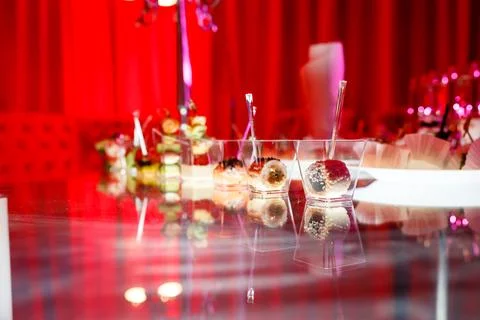 Buffet table with toasts and snacks and desserts in red tones Stock Photos