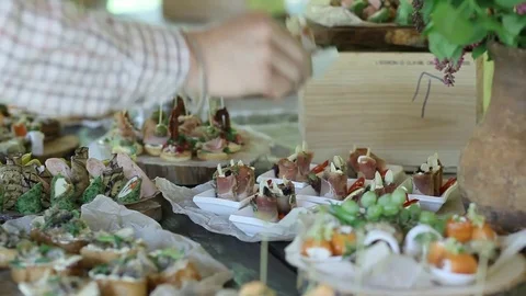 Buffet table. The waiter takes snacks. Italian Cuisine outdoors. Stock Footage 83365928
