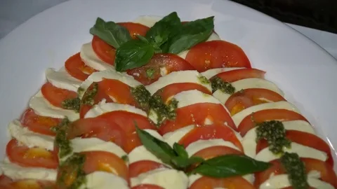 Buffet: tomatoes with cheese are on the plate Stock Footage 79278775