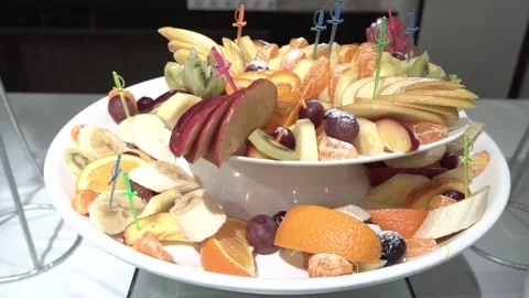 Buffet on a white table. fruit on a large plate. fruit table setting Stock Footage 225811883