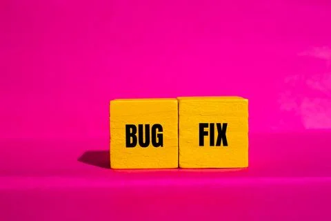 Bug fix message written on yellow wooden cubes with pink background. Conceptu Stock Photos