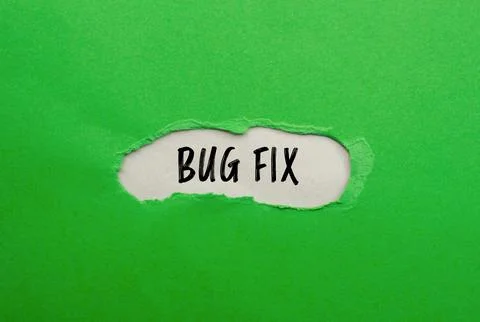Bug fix words written on ripped green paper with gray background. Conceptual  Stock Photos