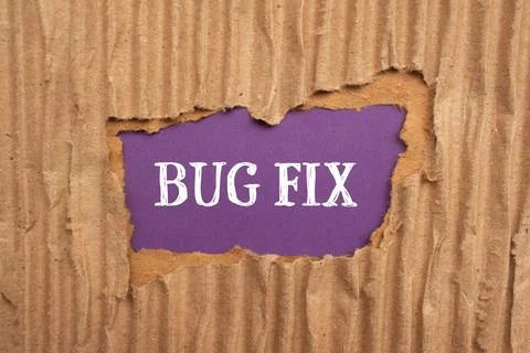 Bug fix words written on ripped cardboard paper with purple background. Conce Stock Photos