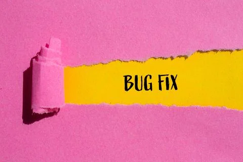 Bug fix words written on ripped pink paper with yellow background. Conceptual Stock Photos