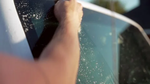 Bug Removal From SUV Windshield With Hand Cleaning Stock Footage 321683117
