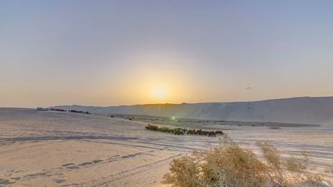 Buggies in sand desert at the sunset timelapse Stock Photos