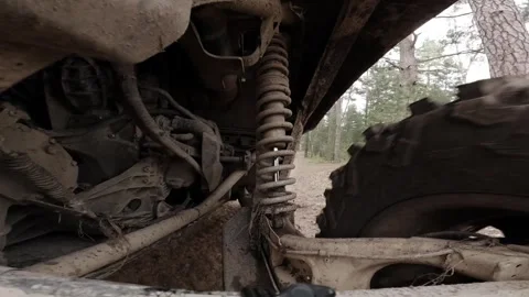 Buggy car suspension operation. Bottom view of the car. A car is driving along a Stock Footage 274503221