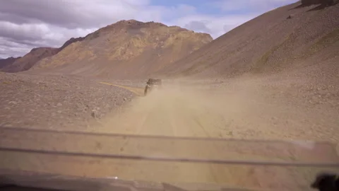 Buggy driving on dusty mountain road Stock Footage 318968809