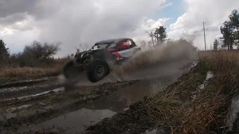 Buggy Maverick X3 flies through a puddle Stock Footage 156655135