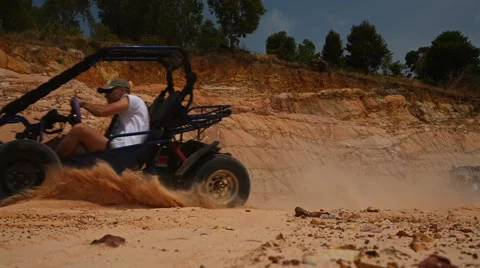 Buggy rushes by, raising clouds of sand close up Stock Footage 49403871