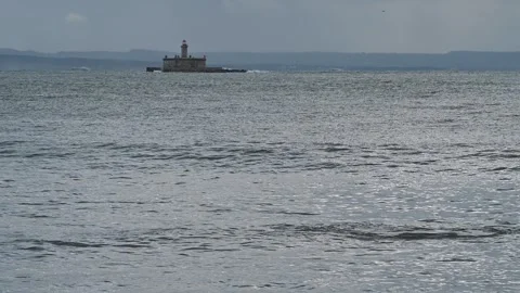 Bugio lighthouse centered on calm ocean horizon Video stock 329365787