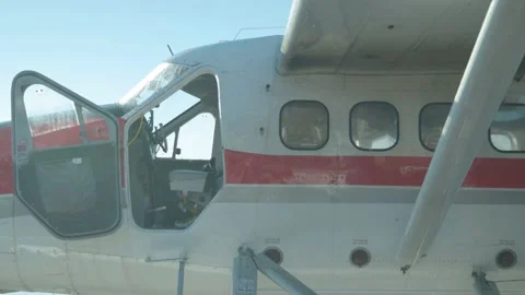 Bugs Swarm around Pontoon Plane as Man Works Inside Stock Footage 201741717