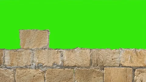 Build and break a tuff stone wall. Red bricks installing, building wall. Conc Stock Footage 168101802