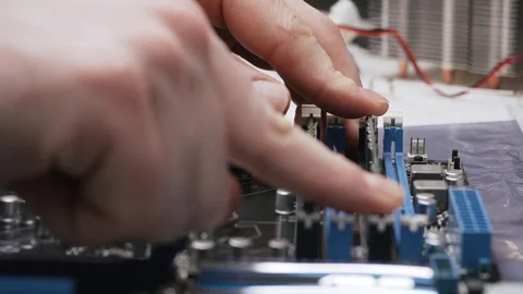 Build a computer, close-up view, 4K. A male service worker installs the RAM Stock Footage 105075146