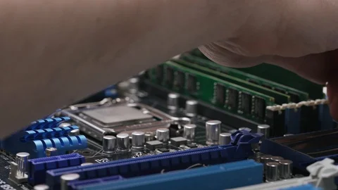 Build a computer, close-up view, 4K. A male service worker installs the RAM Stock Footage 105075171
