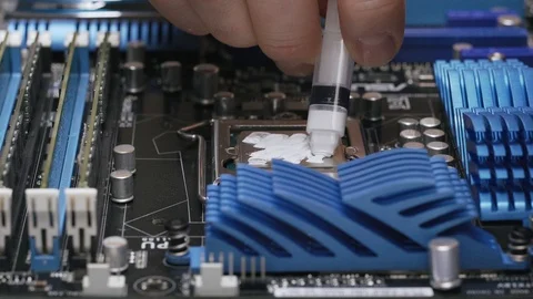 Build a computer, close-up view, 4K. A male service worker applies a layer of Stock Footage 105075722