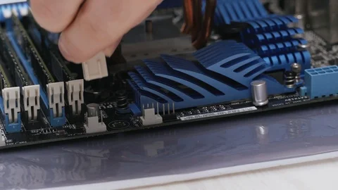 Build a computer, close-up view, 4K. A male service worker connects a CPU Stock Footage 105076314