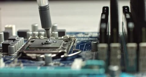 Build computer concept. Close-up shot of applying thermal paste on cpu. 4k Foto stock