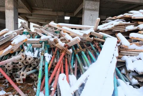 Build. Construction materials on which snow falls. Stock Photos