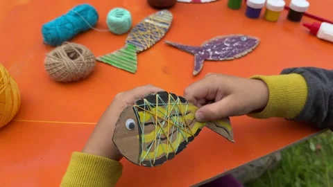 Build a fish model from cardboard, thread, and paint Stock Footage 320497991