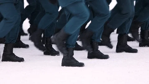 Build soldiers in winter uniform marching on the snow-covered square in the para Stock Footage 101835312
