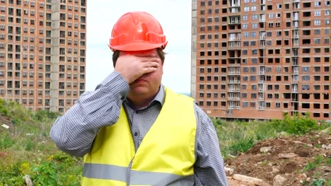 Builder is afraid (man covers his eyes with hands) - construction site Stock Footage 111872933