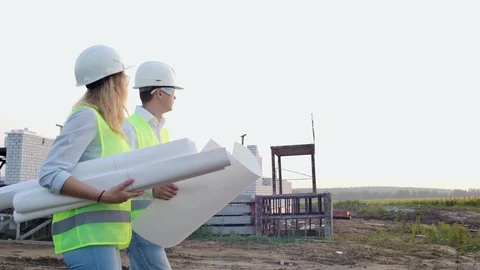 The builder and architect man and woman are discussing the construction plan of Video stock 114274012