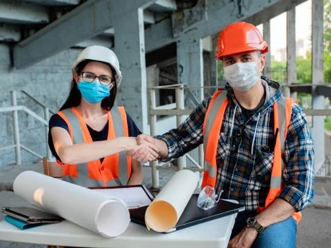 Builder and architect signed a contract for the reconstruction of the building Stock Photos