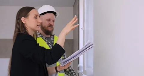 Builder and client discuss interior design, selecting options for home Stock Footage 275036454