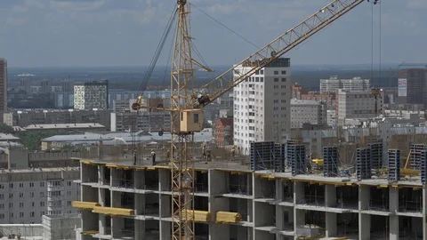 Builder and crane working on Unfinished Residential Building Construction Site Stock Footage 98597469