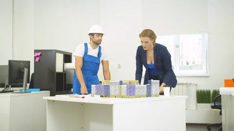 Builder and engineer discuss project of houses Stock Footage 121804666