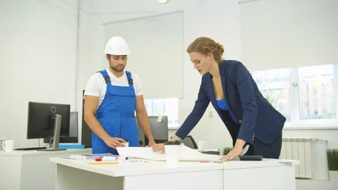 Builder and engineer in the office, woman draw on whatman paper with pencil and Stock Footage 121815313