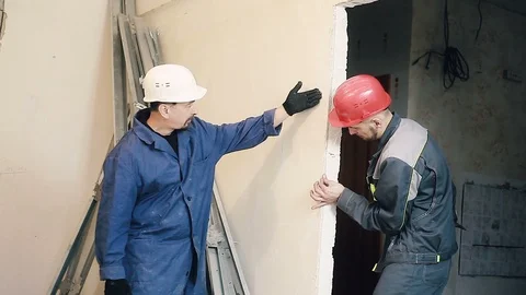 Builder and Manager checking colleagues work Stock Footage 99778605